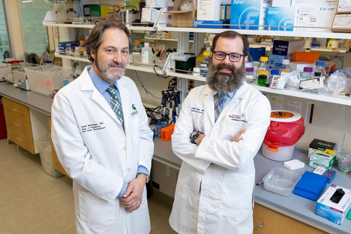 Bachmann and Bupp standing in lab