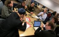 Group of People Discussing Projects at a Table