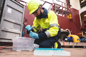 Matthias Egger collecting samples on board the Ocean Cleanup vessel.