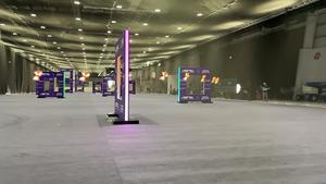 Timelapse photo of racing drone flying through final racing gate