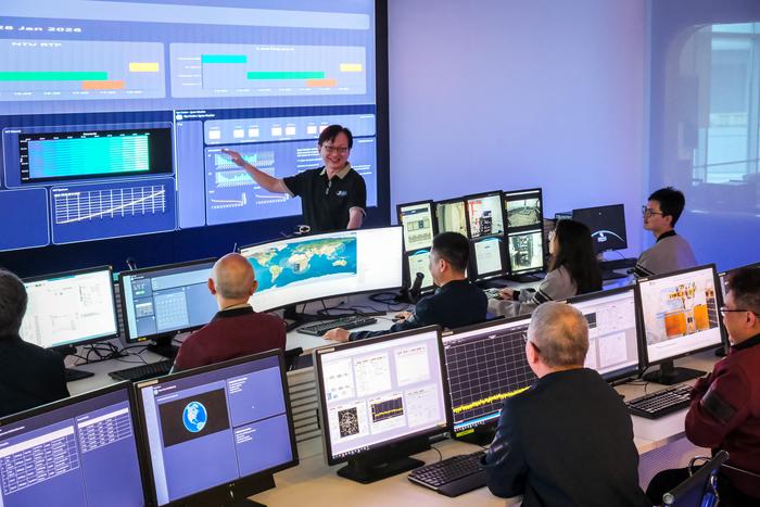 Satellite Research Centre Executive Director Mr Lim Wee Seng (top) briefing his team of scientists and engineers