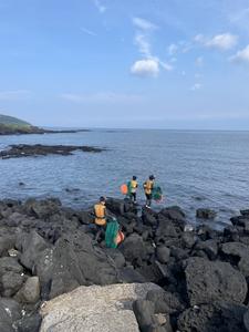 Group of Haenyeo divers on a rocky shore