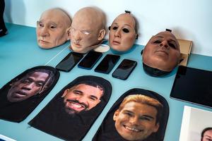 Masks used by criminals to carry out presentation attacks, displayed on a table