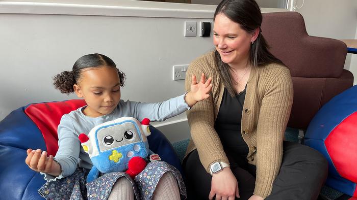 Mya, age 3, and her mum, Vicky, playing with the AI toy, Gabbo, during an observation at the University of Cambridge’s Faculty of Education.