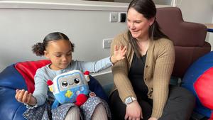 Mya, age 3, and her mum, Vicky, playing with the AI toy, Gabbo, during an observation at the University of Cambridge’s Faculty of Education.