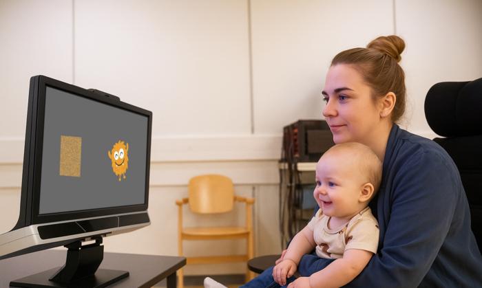 Baby participates in experiment by looking at monster on screen