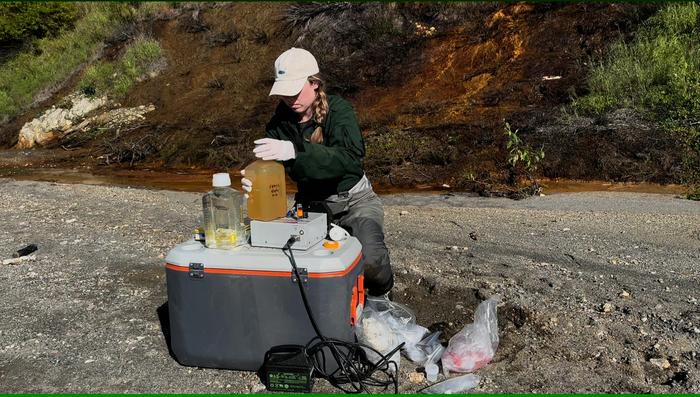 Taylor Evinger collecting water chemistry samples