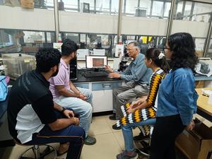 Uday Maitra with students in the lab