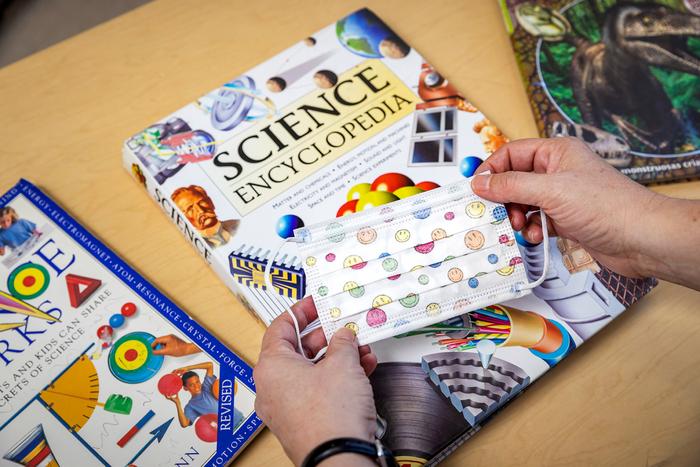 School books and a child's mask
