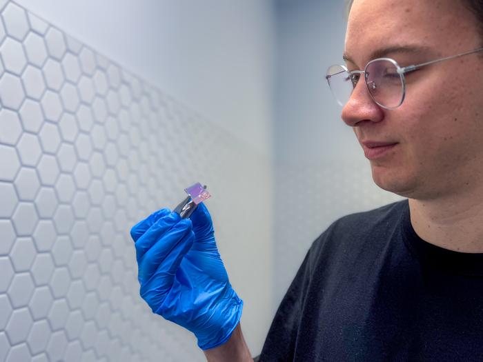 Daniel Tibben holding device. Credit: RMIT