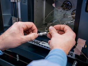 Researcher installs a new trapping column for liquid chromatography