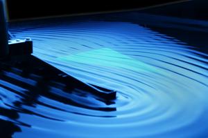 Wavemaker sending waves at a triangular object