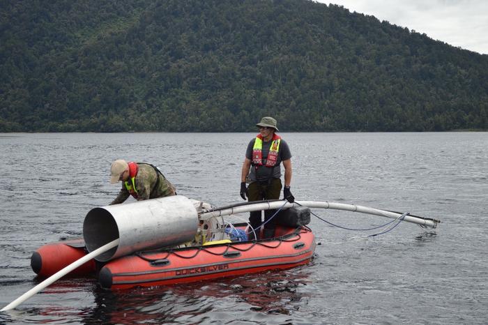 Study authors Jamie Howarth and Sean Fitzsimons collect a sediment core from Lake Paringa, New Zealand