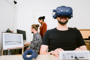 PhD student Peter Bang demonstrates a VR headset