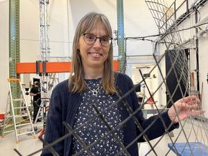 Karin Lundgren, Professor at Chalmers University of Technology, shows a reinforcement mesh made of carbon fibre textiles.