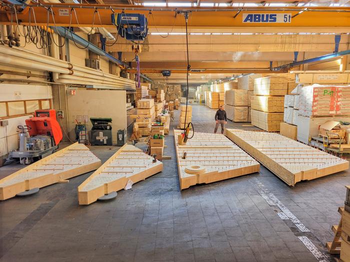 Prefabricated glued-laminated timber segments make the new floor slab system cost-effective.