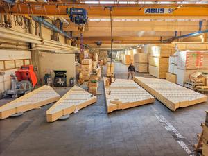 Prefabricated glued-laminated timber segments make the new floor slab system cost-effective.