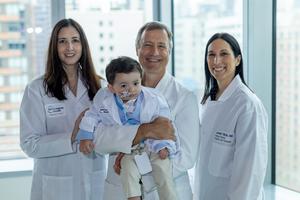 Baby Benjamin Carstens with pediatric hepatologist Dana L. Goldner, MD, pediatric liver surgeon Adam Griesemer, MD, and pediatric hepatologist Jennifer M. Vittorio, MD.