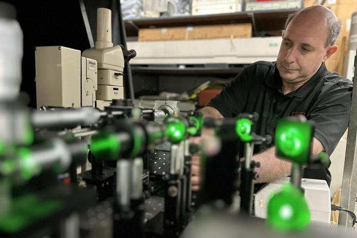 Michael Pravica examines the affects of X-rays on battery regeneration in his physics lab.