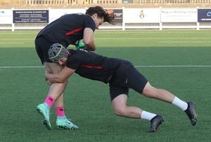 A player is tackled in training