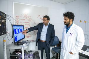 Study authors Drs. Sachin Patel and Saptarnab Naskar examine a heat map showing where the mice moved when exploring the threatening odor
