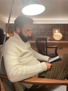 Gonçalo reading in a quiet moment outside the clinic and laboratory routine