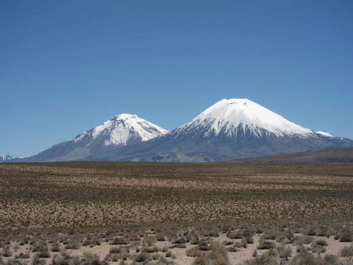 Parinacota and Pomerape volcanoes surrounded by ignimbrite deposits