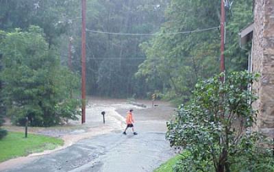 Man Crossing a Flooded Street