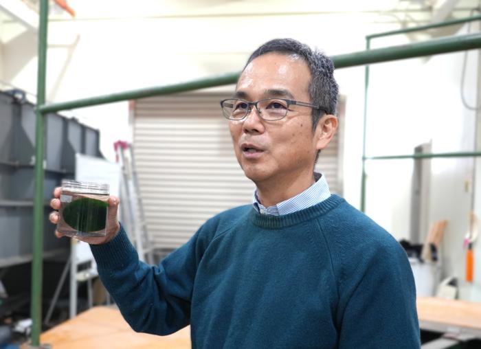 Nakayama holds a marimo, a subject he has long researched