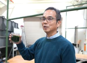Nakayama holds a marimo, a subject he has long researched