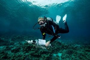 Dr. Herdís Steinsdóttir deploying an instrument near the reef in Eilat
