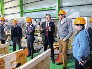 DOE Under Secretary for Science Darío Gil is pictured (fifth from left) in Japan, with the opened crates containing PPPL’s X-ray imaging crystal spectrometer.