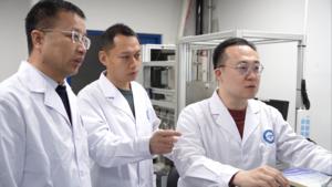 The main authors of the study are discussing experimental data in front of the Fischer–Tropsch synthesis reactor