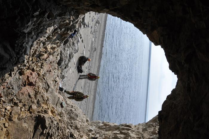 Team in cave at Arctic coast