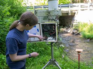 Researcher points to a sensor in a data logger