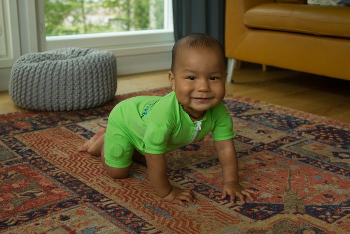 An infant wearing the MAIJU smart jumpsuit