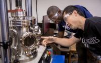 Students in Front of a High-Temperature High-Vacuum Molding System