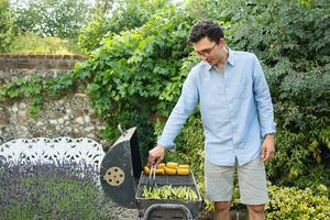 Oliver Pain barbecuing in the English countryside during his wife’s birthday celebration in summer 2025.
