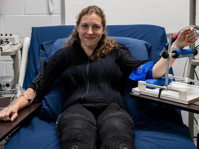 First author Kat Fisher demonstrates the experimental equipment