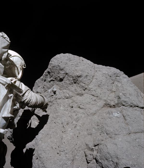 Apollo 17 astronaut sampling boulder at Station 7