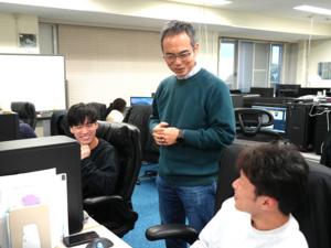 Nakayama talks to his students about their research