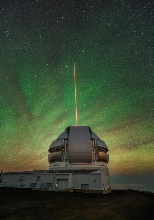 The Gemini North telescope’s laser guide star beams up into the atmosphere
