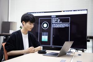 Higashinaka Lab PhD students testing AI dialogue systems