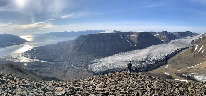 Researcher hiking to the next sampling site on Svalbard