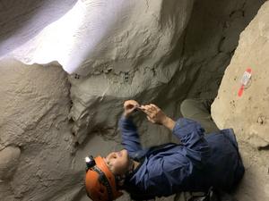 Dr Andrea Jalandoni studies finger flutings at a cave site in Australia