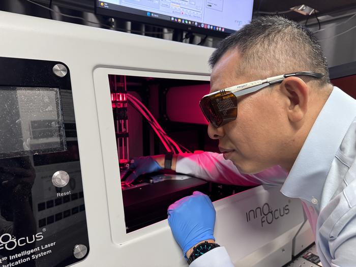 Dr Han Lin operates a nanofabrication system at RMIT University