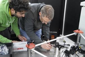 Ruben Tandon and Jonas Kuehn work on the PLACID instrument.