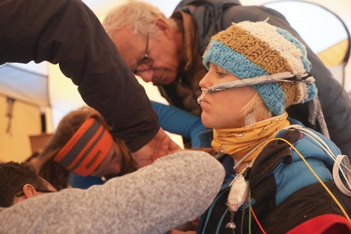A participant in the clinical trial is prepped to be buried in the snow.