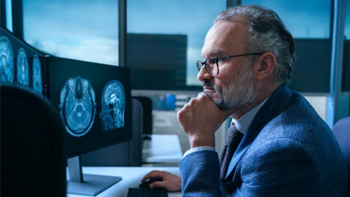 Dr. David Jones reviews brain scans on a computer at Mayo Clinic.