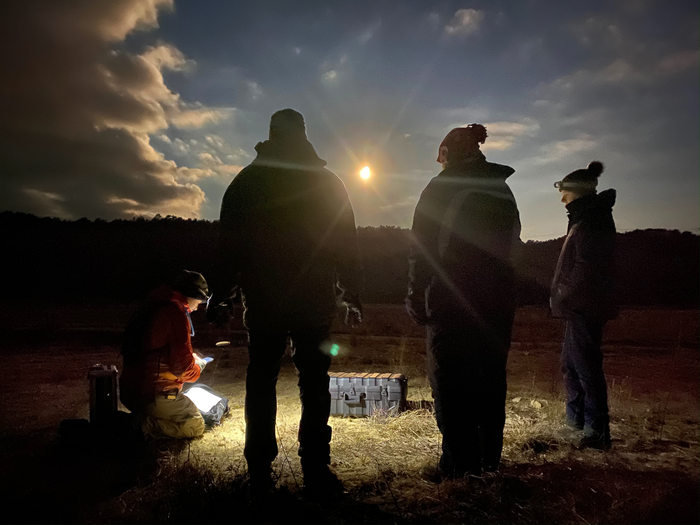 •	UMassAir pilot and co-author Ryan Wicks conducts pre-flight check of the UAV under the full moon at dawn.